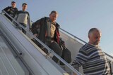 Western observers disembark from plane