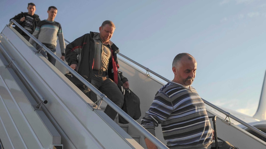 OSCE observers disembark from a plane upon their arrival at Boryspil International airport outside Kiev.