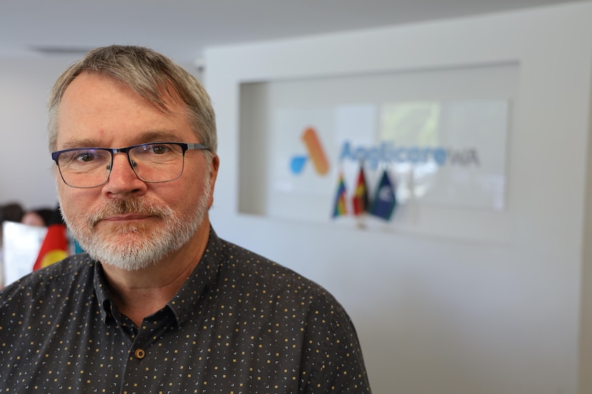 A man with glasses and a beard.