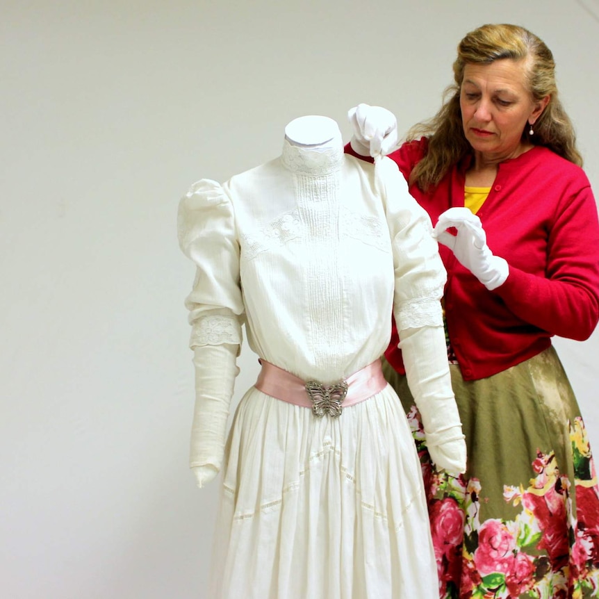 Jenny Gall, curator at the National Film and Sound Archive, with the dress from Picnic at Hanging Rock.