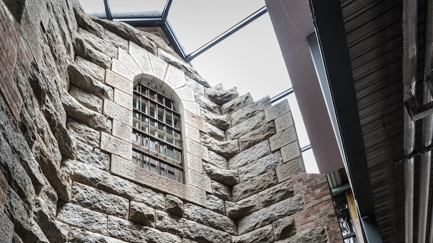 Old sandstone and granite wall now forming part of the theatre's internal structure