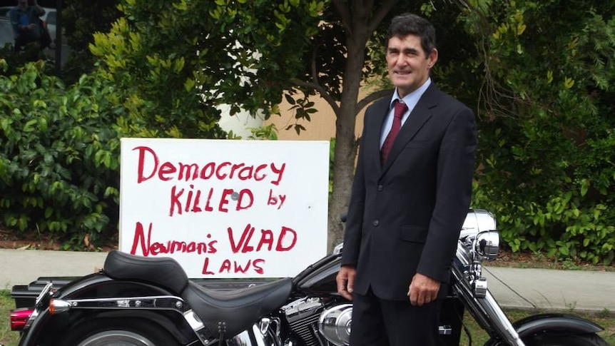 Nicklin MP Peter Wellington with a motorcycle outside Maroochydore Court House