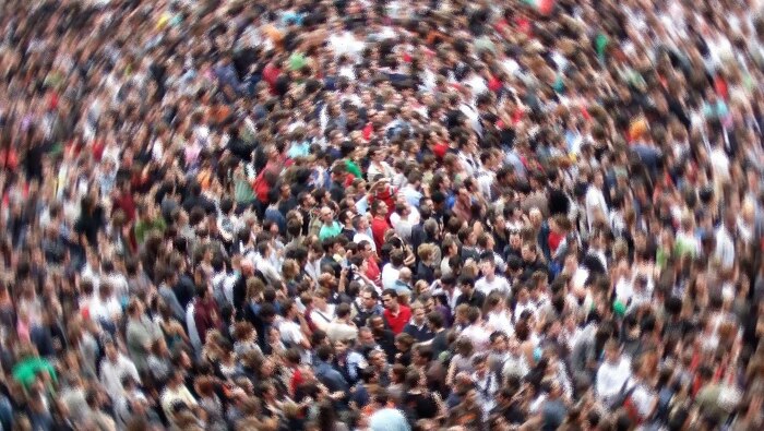A blurred image from high of a crowd of people.
