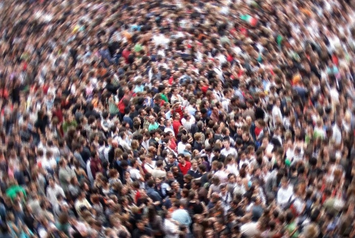 An aerial view of a large crowd, with blurring as of the camera spinning.