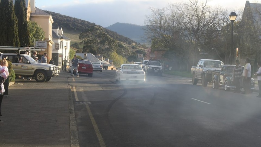Car wheels smoke in Richmond's main street