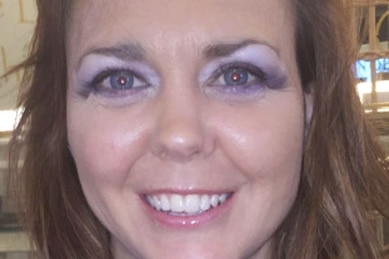 Smiling headshot of Simone Rothe wearing makeup.