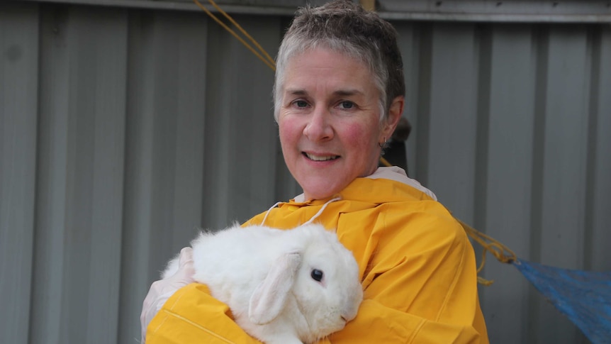 Gretel Whitting holding her white rabbit named Malibu.