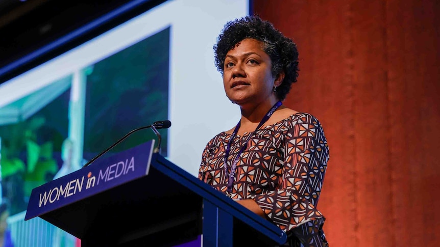 A woman at a podium giving a speech 