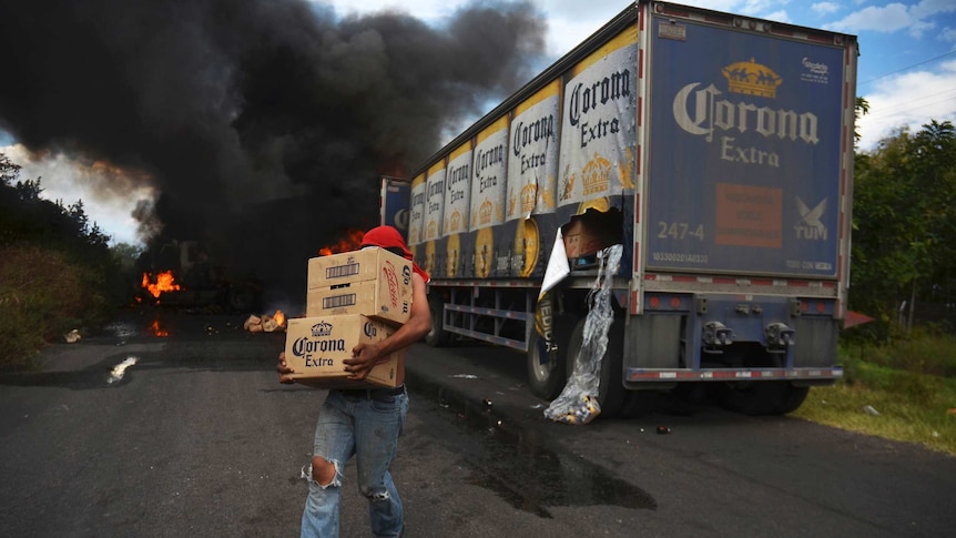 Looter takes beer from burning Corona truck
