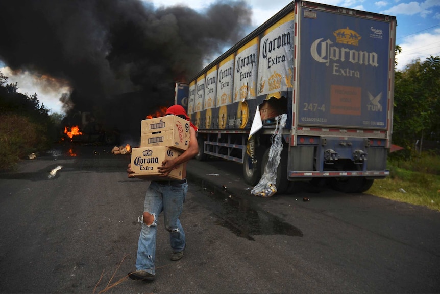 Looter takes beer from burning Corona truck
