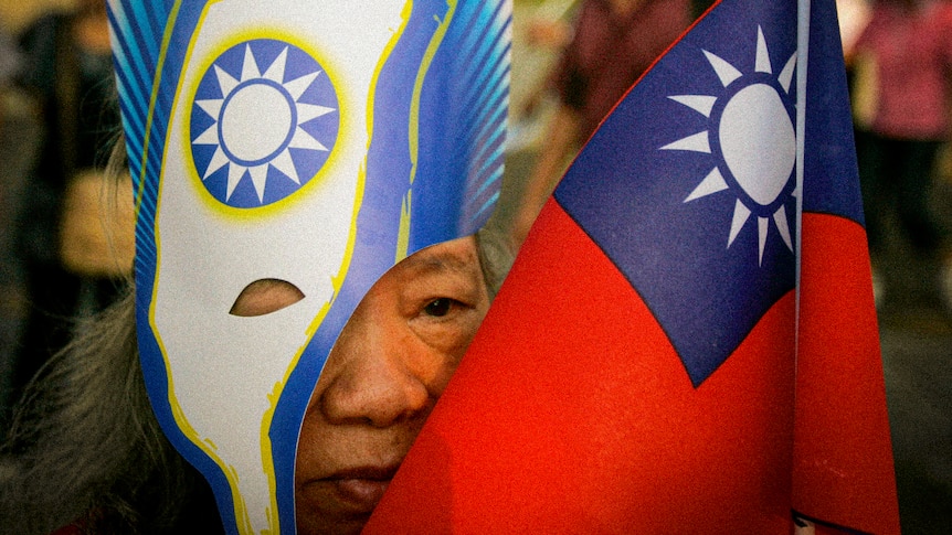 An older Taiwanese woman in a mask with Keep Going Taiwan while her face is obscured by a Taiwanese mask.
