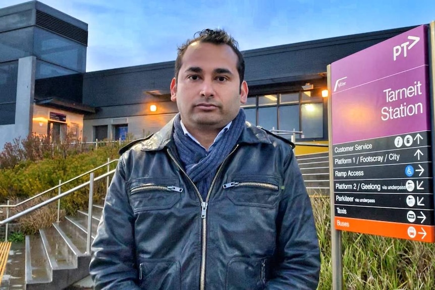 Arnav Sati, in a black jacket and scarf, stands at the front of the Tarneit V/Line train station.