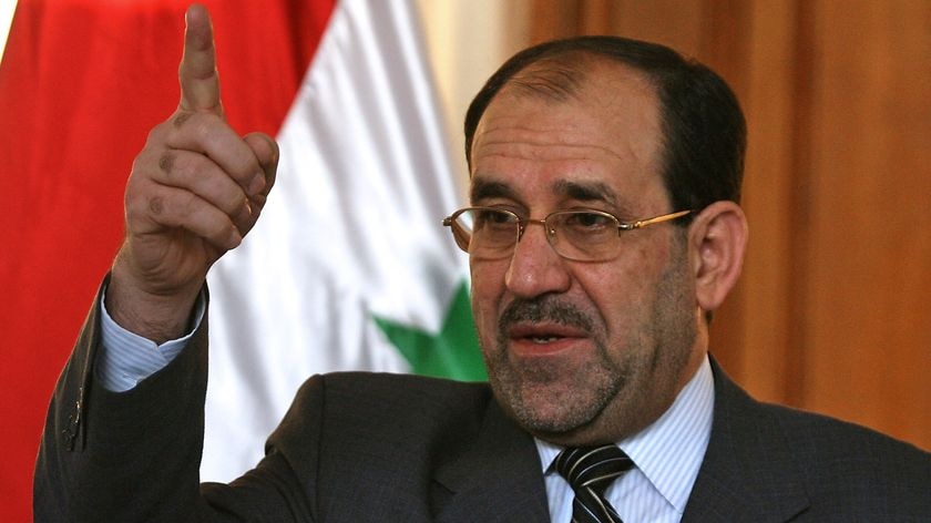 Nouri al-Maliki gestures during a press conference