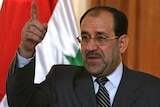 Nuri al-Maliki gestures during a press conference