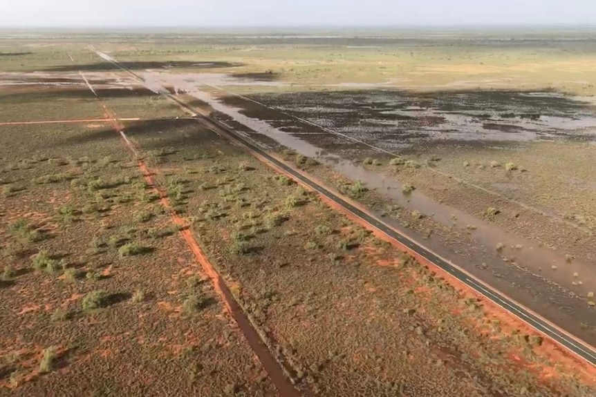 An aerial photo of flood waters across a major highway