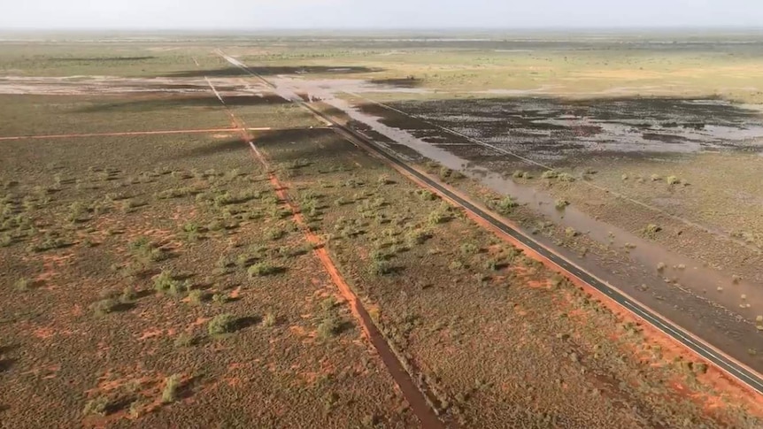 An aerial photo of flood waters across a major highway