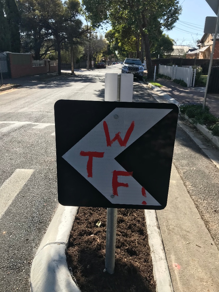 An Adelaide street sign defaced with graffiti.