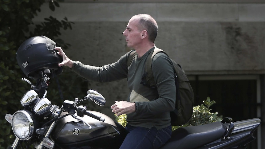 Greek finance minister Yanis Varoufakis arrives on a motorbike for a cabinet meeting in Athens.