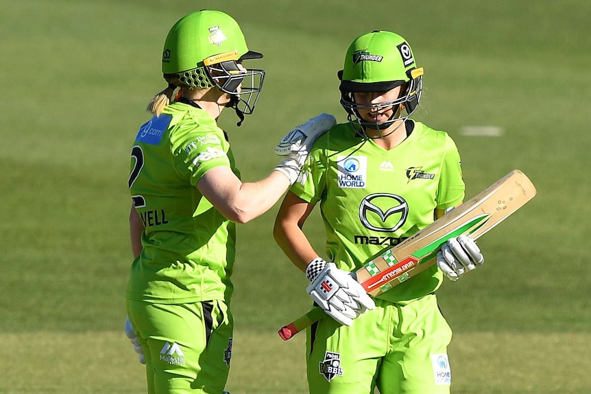 A Sydney Thunder WBBL player congratulates her teammate after they beat Brisbane Heat.