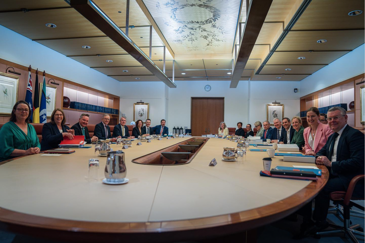 A photo of Anthony Albanese's cabinet posing for a photo around a large oval table