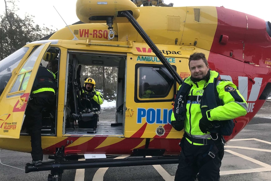 Sergeant Kriss Lawler near helicopter.