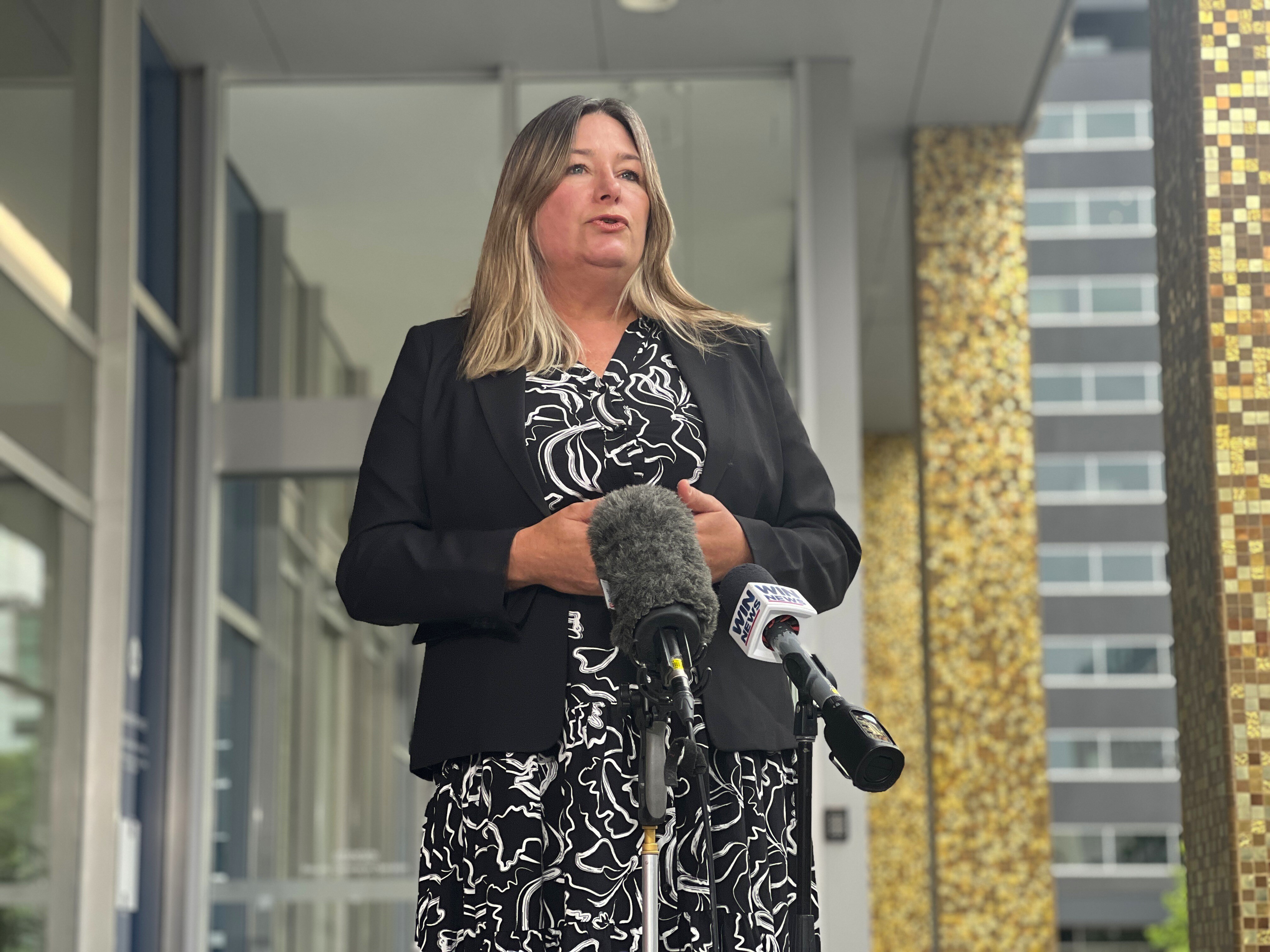 Yvette Berry speaks into microphones.