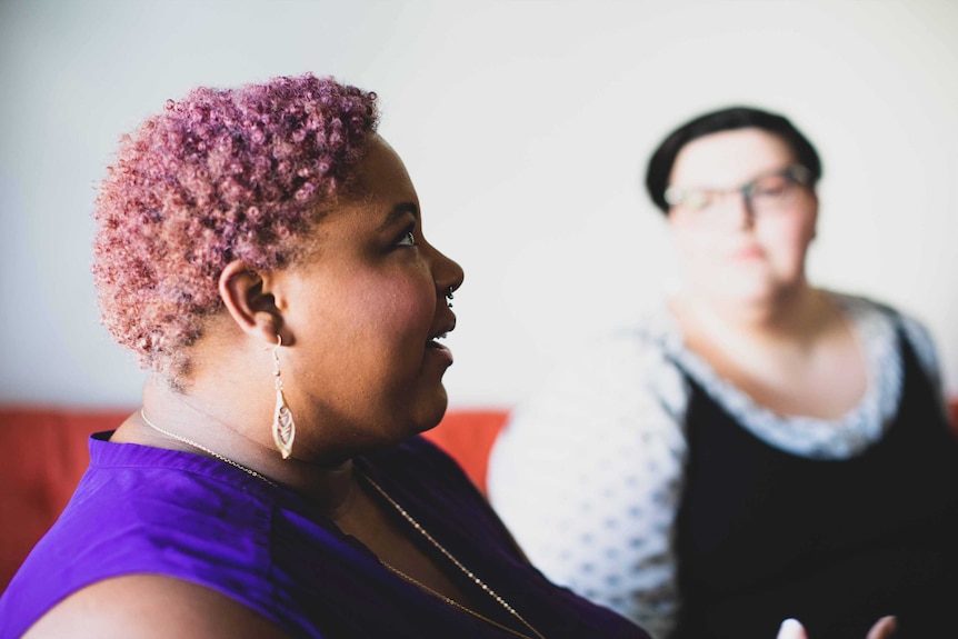 Woman talking to friends in a group context to depict conversations about chronic pain