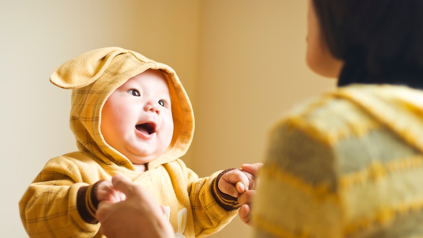 Baby singing with parent