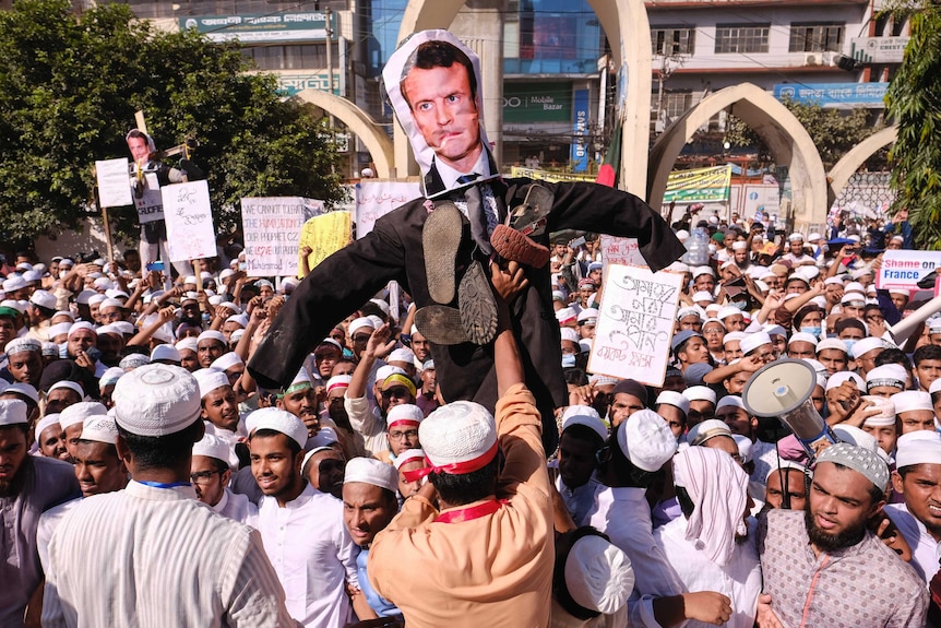 Supporters of Islamist parties carry an effigy of French President Emmanuel Macron during a protest.