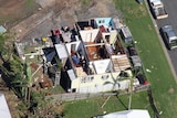 An aerial shot of houses damaged by a cyclone.