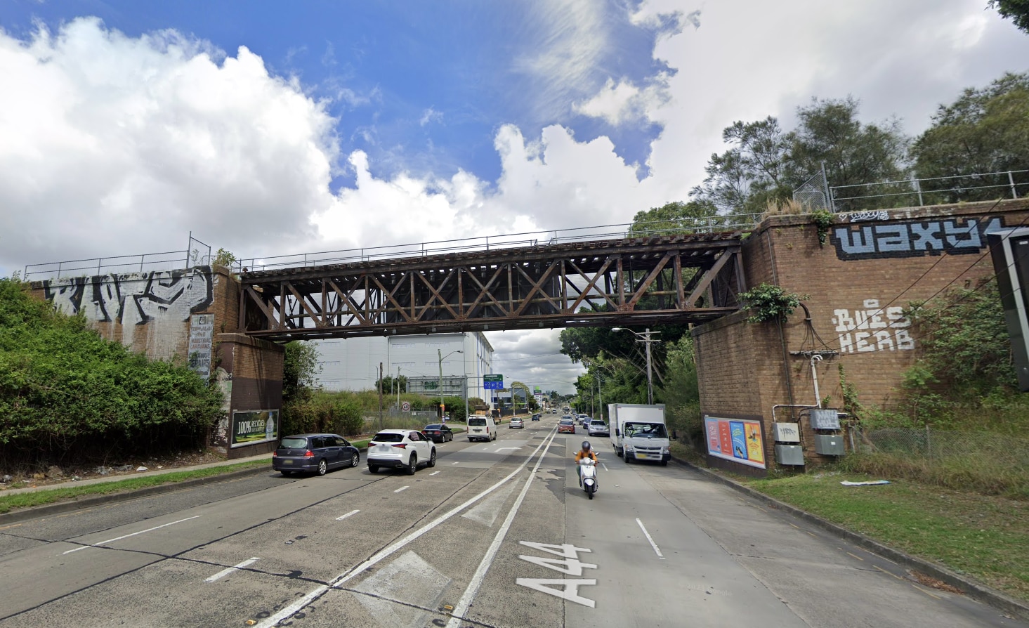 An old bridge over five lanes of road traffic