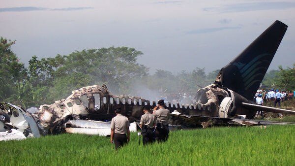 Rescue workers have started removing bodies from the burnt out plane.