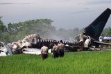 Rescue workers have started removing bodies from the burnt out plane.