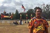 Rodney Kelly stands in front of the fire at the tent embassy in Canberra.