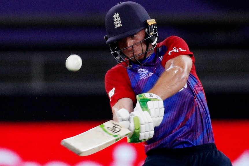 Jos Buttler hits a ball to the boundary.