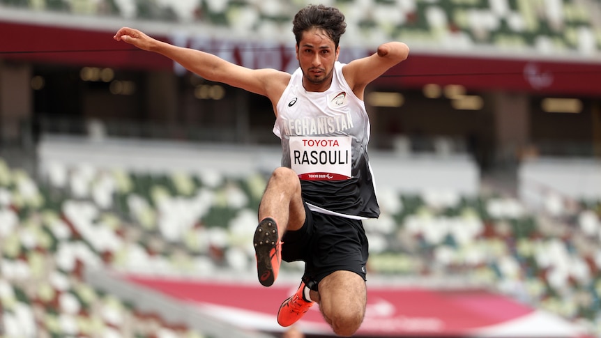 An Afghan male Paralympian competes in a long jump competition in Tokyo.