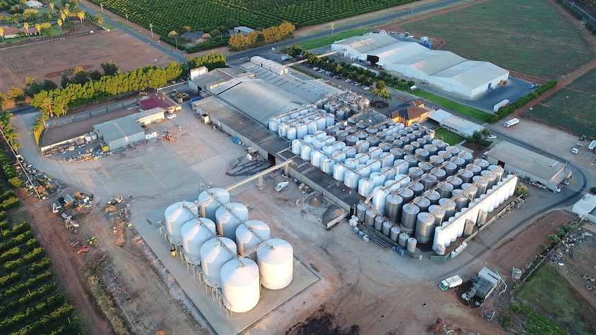 A drone image showing large wine tanks and buildings surrounded by vineyards