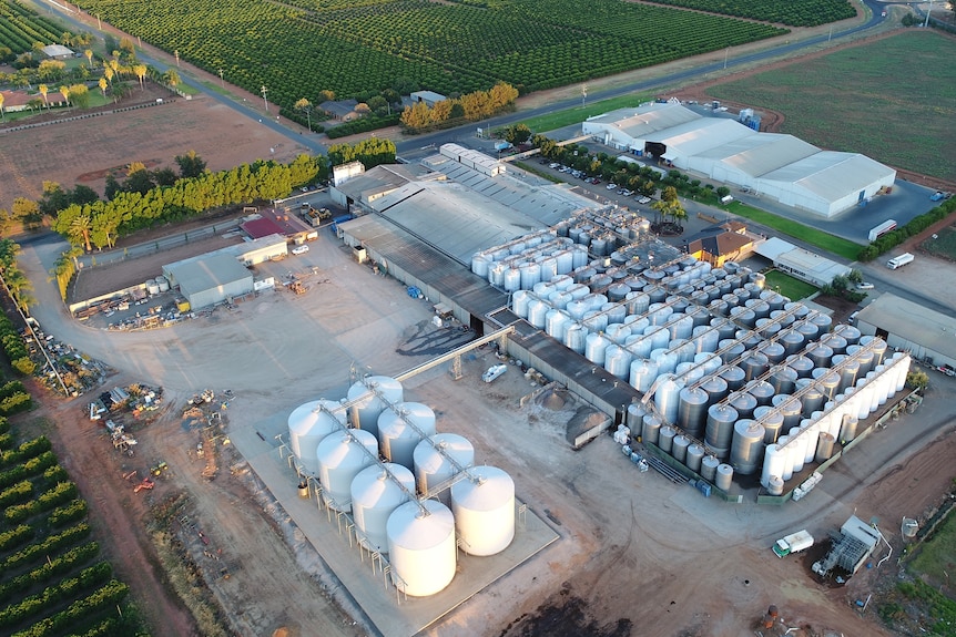 A drone image showing large wine tanks and buildings surrounded by vineyards
