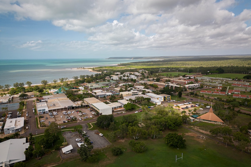 A drone shot of houses and a small town right near a beach 