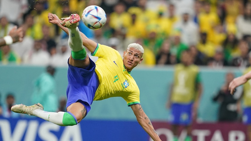 Richarlison of Brazil watches the ball closely on his boot as he connects with a scissor kick against Serbia at the World Cup.