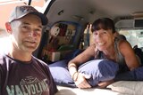 Jennifer Williams and Michael Boyd stand at the rear door of their converted campervan.
