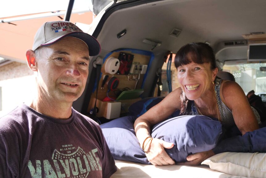 Jennifer Williams and Michael Boyd stand at the rear door of their converted campervan.