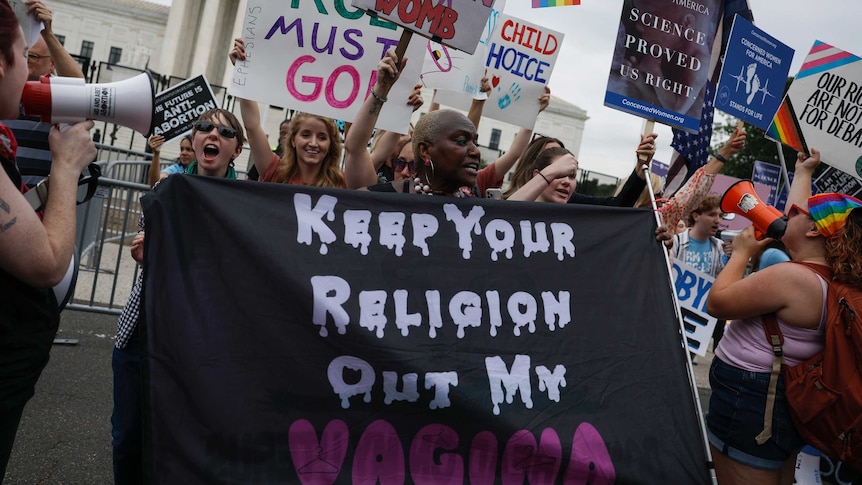 Pro-abortion rights activists demonstrates near an anti-abortion rights group outside of the US Supreme Court Building.