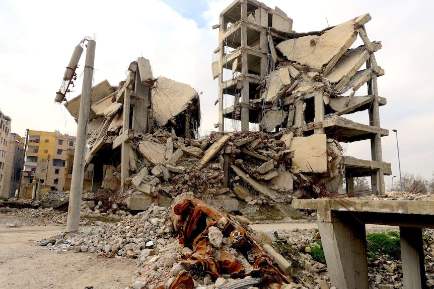 Piles of concrete rubble where an apartment block once was.