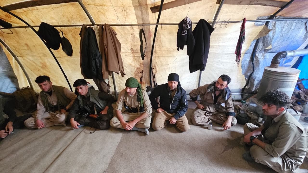 A group of men wearing neutral colours.