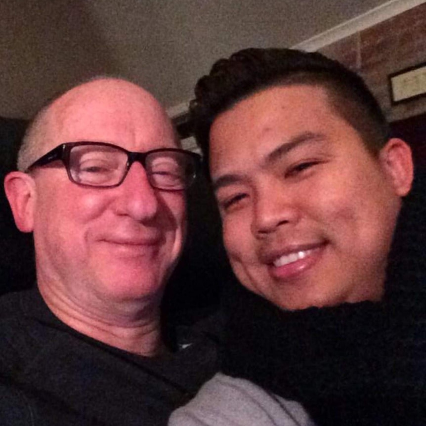 A close up of two men smiling for the camera.