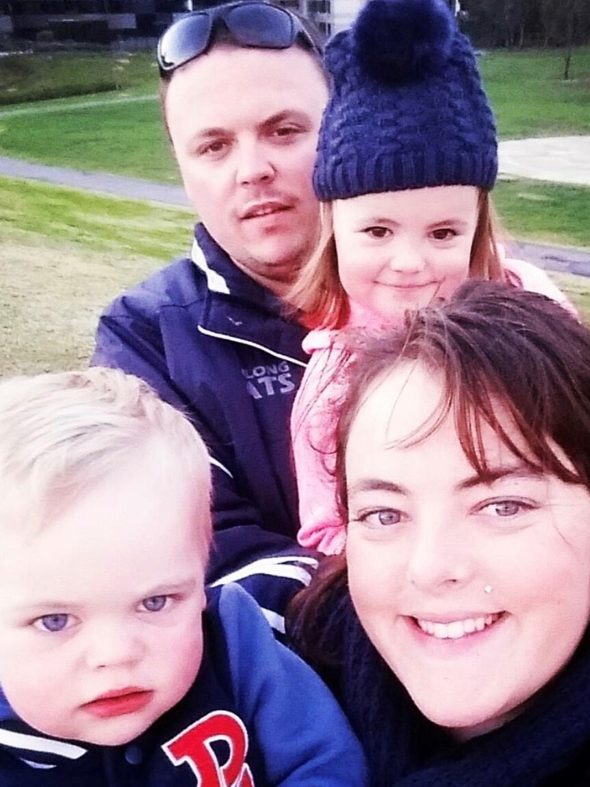 Family selfie with a woman, man and two young children.