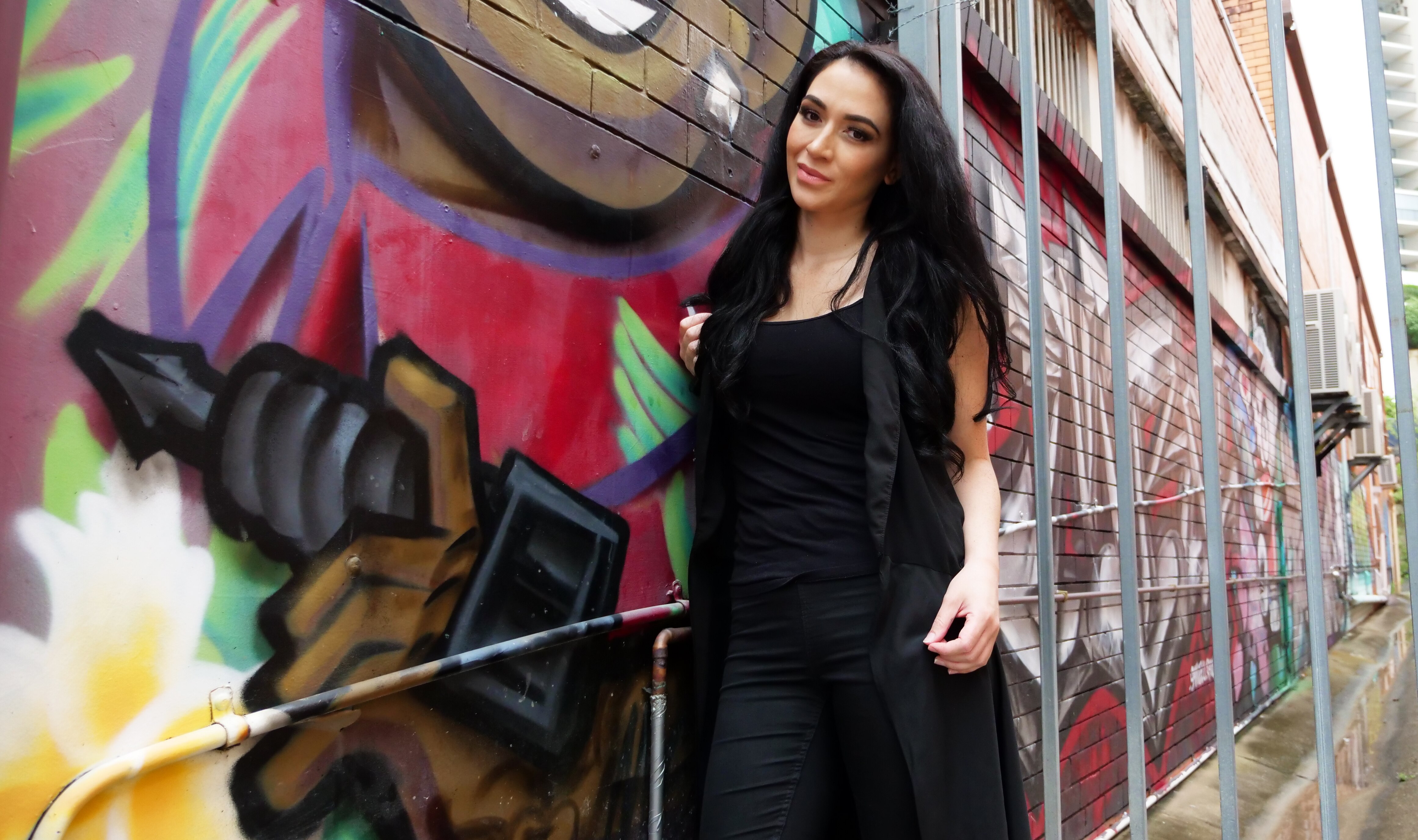 woman standing next to brick wall