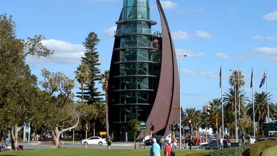 Two people walk past the Bell Tower