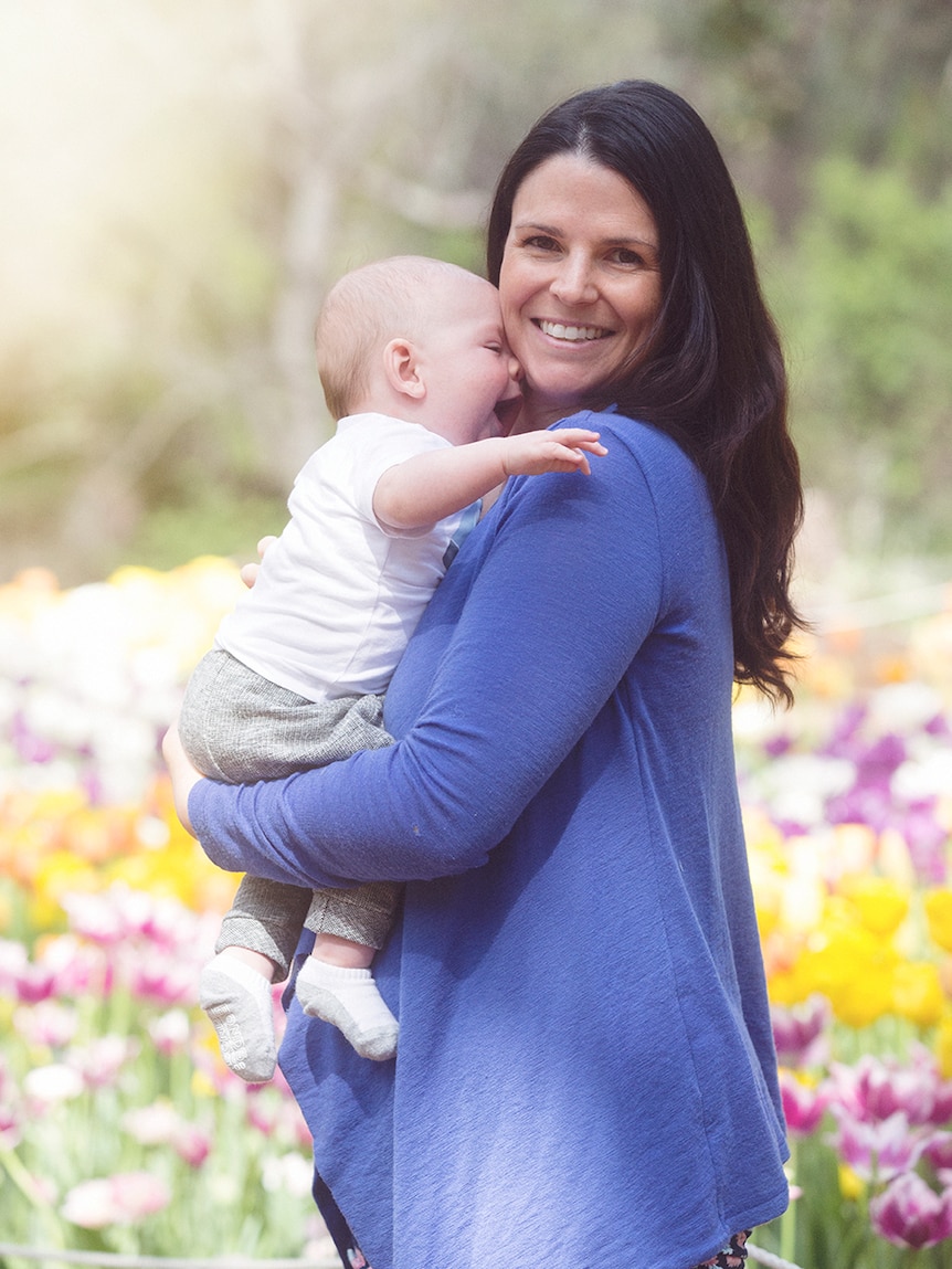 Peta and Rex Drury post for a photo in the garden to depict what to consider before announcing pregnancy or miscarriage online.